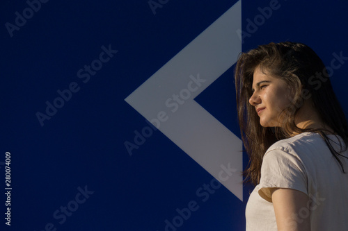 Young girl, white arrow, direction