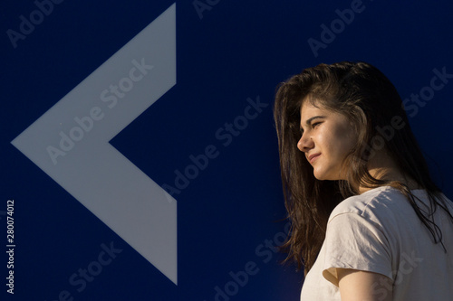 Young girl, white arrow, direction