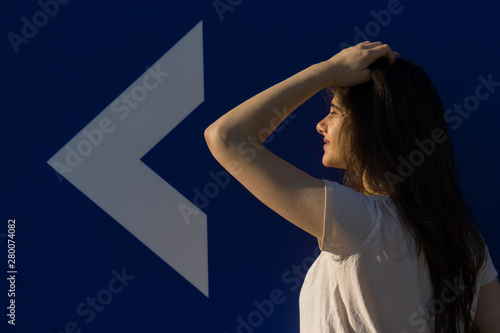Young girl, white arrow, direction
