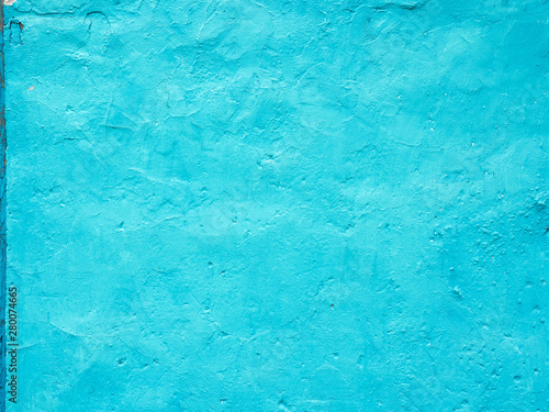 Old grungy turquoise painted vintage painted wall old paint with cracks background texture with copypaste