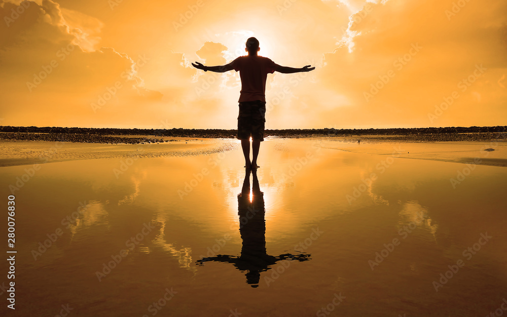 Silhouette of Man Raising His Hands or Open arms when sun rising up