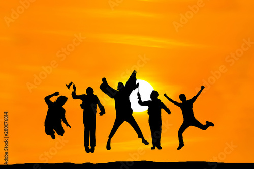 Silhouette of happy people jumping over sunset, concept about having fun