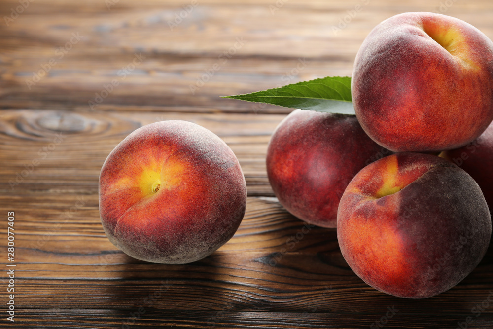 Bunch of ripe organic peaches in pile on textured table background. Local produce harvest heap on vintage style countertop. Clean eating concept. Top view, close up, copy space for text. Bunch of ripe organic peaches in pile on textured table background. Local produce harvest heap on vintage style countertop. Clean eating concept. Top view, close up, copy space for text.
