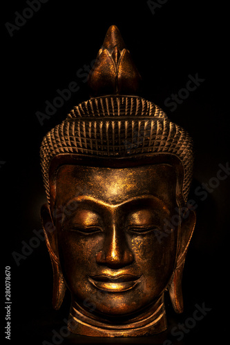  the head of the Buddha statue in gold on a black background