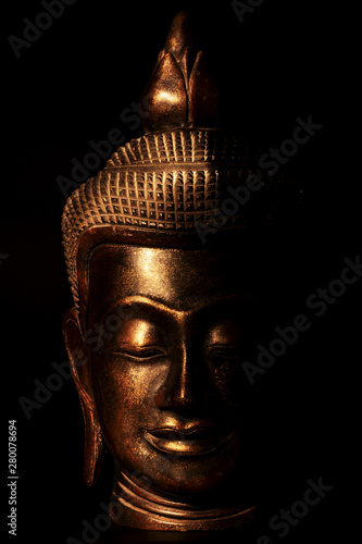  the head of the Buddha statue in gold on a black background