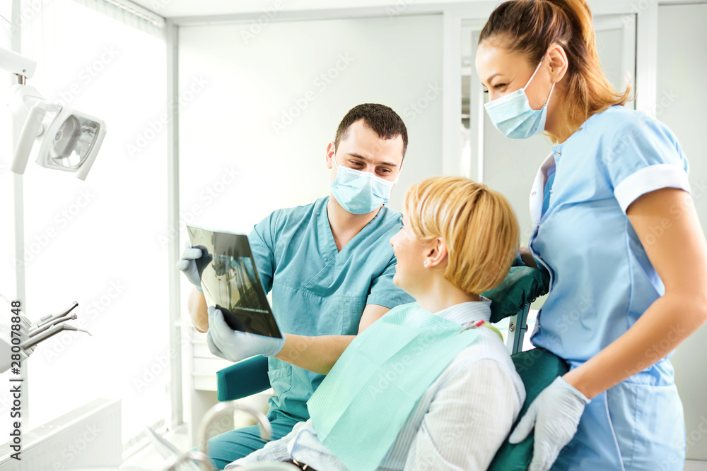 Dentist shows a x-ray image of a girl Dentist shows a x-ray image of a girl