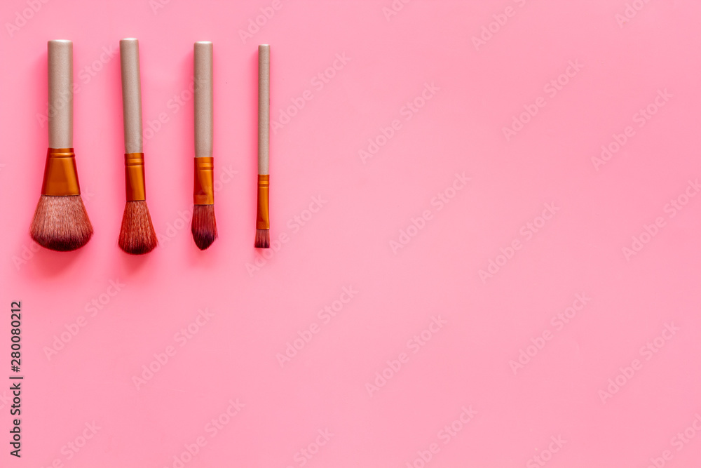 Brushes for make up on pink visagiste work desk background top view copyspace Brushes for make up on pink visagiste work desk background top view copyspace