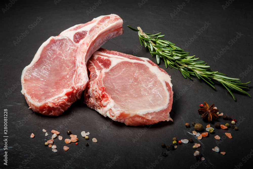 closeup raw ribs with meat served with green rosemary