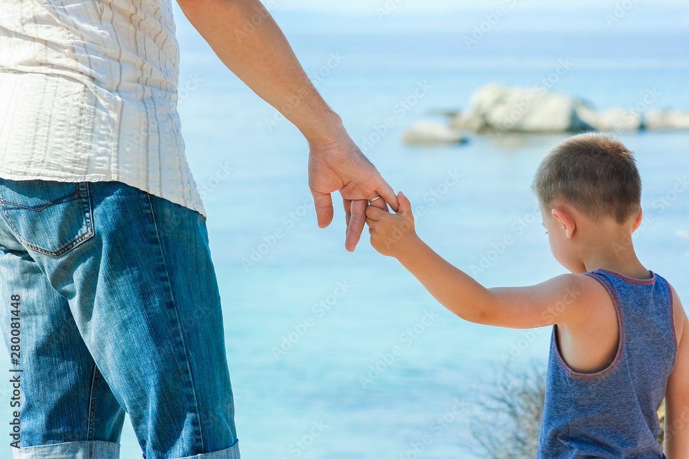 beautiful hands of parent and child by the sea beautiful hands of parent and child by the sea