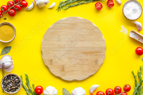 Cutting board in frame of food for chef work on yellow background top view space for text