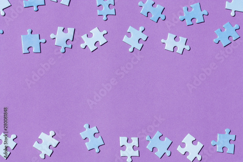 Puzzle pieces on a purple background.