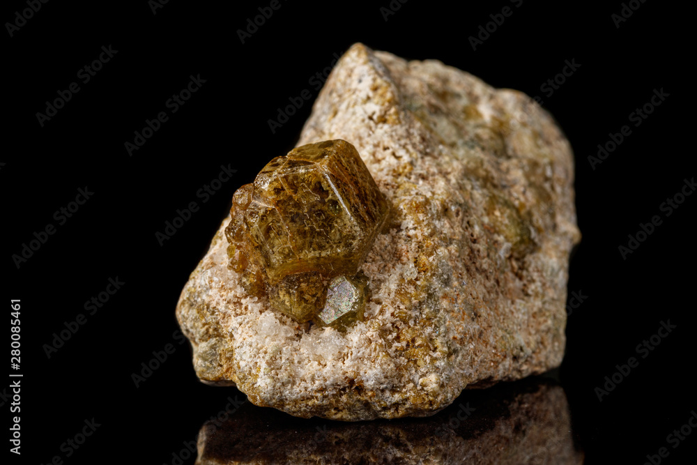 Macro stone Grossular mineral on a black background Macro stone Grossular mineral on a black background