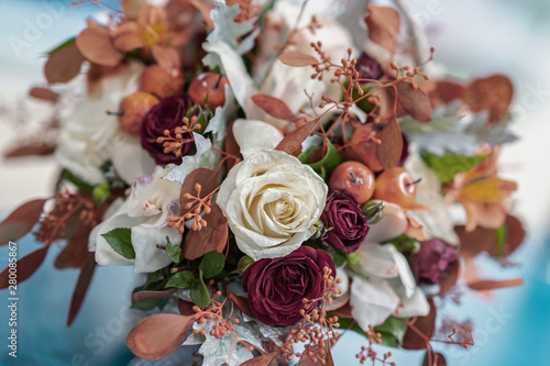 Flower autumn composition from leaves  roses  berries