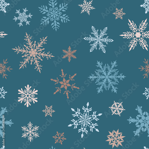 Christmas seamless pattern of complex big and small multicolored snowflakes on light blue background