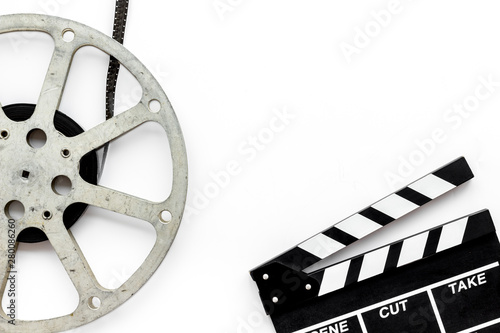 Watch film in cinema with video tape and clapperboard on white background top view