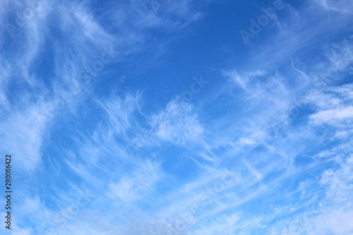 Cirrus clouds on a bright sunny day on a background of blue sky. Natural background.