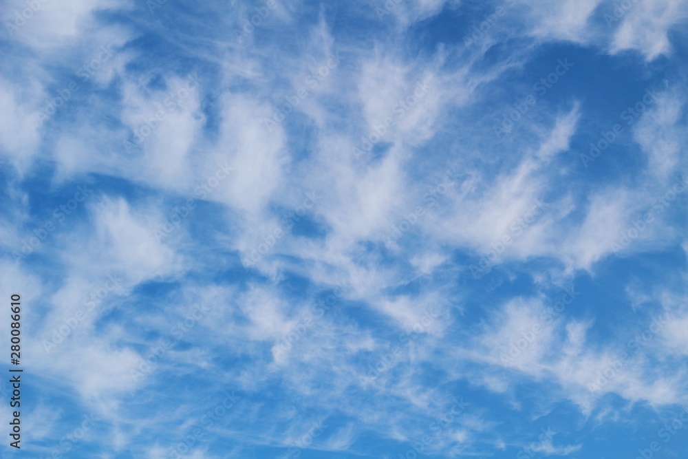 Light cirrus clouds on a blue sky. Natural background.