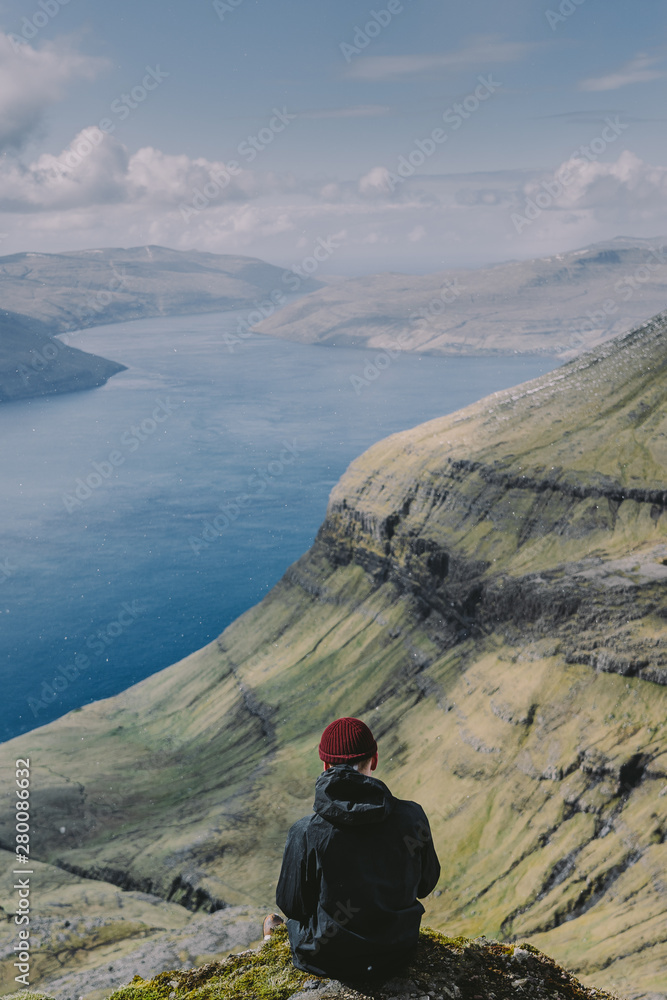 Hiker on top of mountain Faroe Islands Hiker on top of mountain Faroe Islands