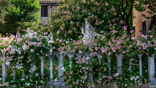 Statue in flower garden in Venice, Italy