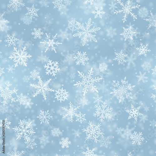 Christmas seamless pattern of complex blurred and clear falling snowflakes in light blue colors with bokeh effect