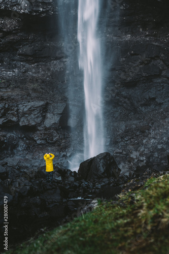 Fossa Waterfall Faroe Islands Traveler in yellow jacket