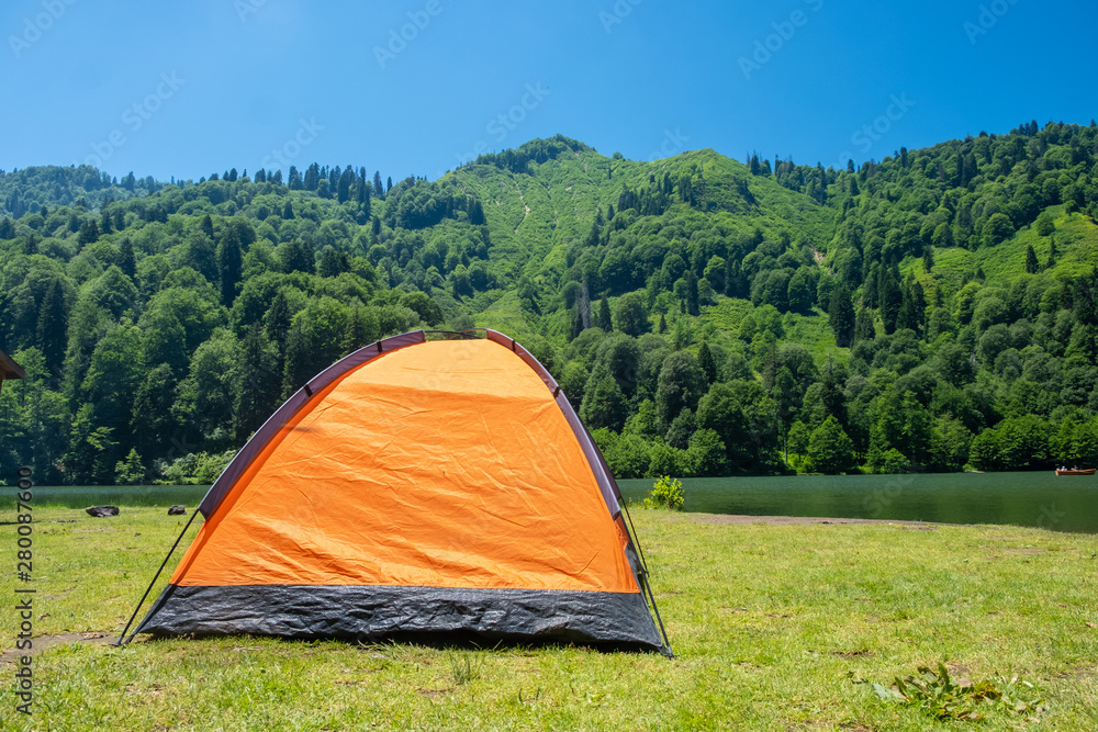 Camping tent at scenic campsite on a lake