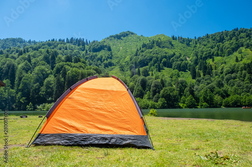 Camping tent at scenic campsite on a lake