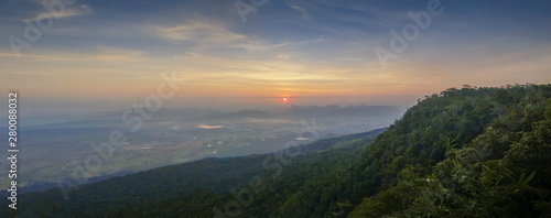 Mountain view panorama 180 degree morning on top hill around with soft fog with yellow sun light in the sky background, sunrise at Nok Aen Cliff View Point, Phu Kradueng National Park, Loei, Thailand.