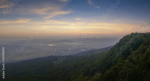 Mountain view panorama 180 degree morning on top hill around with soft fog with yellow sun light in the sky background  sunrise at Nok Aen Cliff View Point  Phu Kradueng National Park  Loei  Thailand.