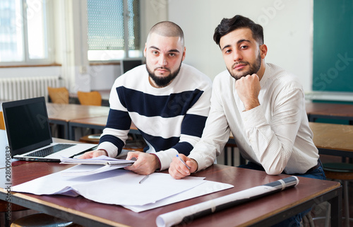 Portrait of two positive male students