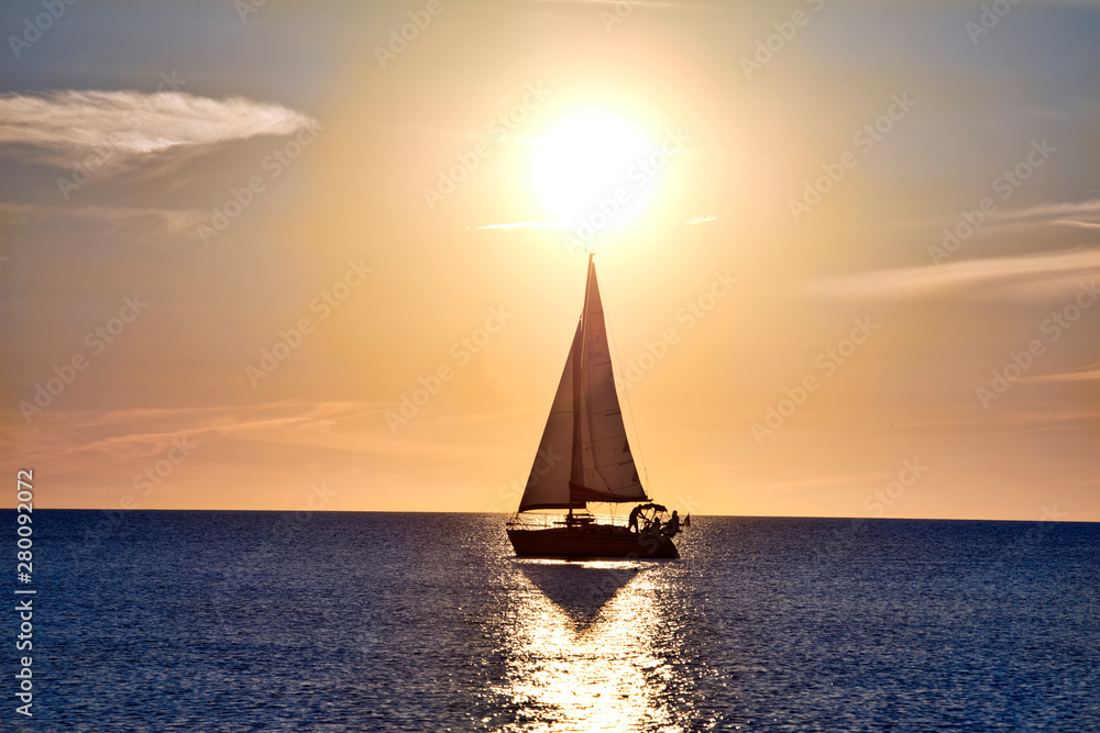 Sailboat under the Sun at Sunset with Shadow