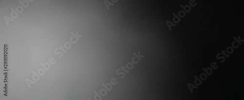 Black and white background with gradient colors of gray in spotlight design with dark border and faint texture