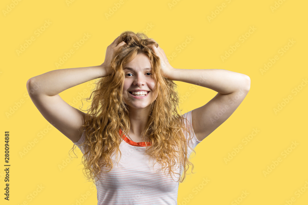 Emotional portrait of a red-haired girl on a yellow background, stormy emotions, business concept. Emotional portrait of a red-haired girl on a yellow background, stormy emotions, business concept.