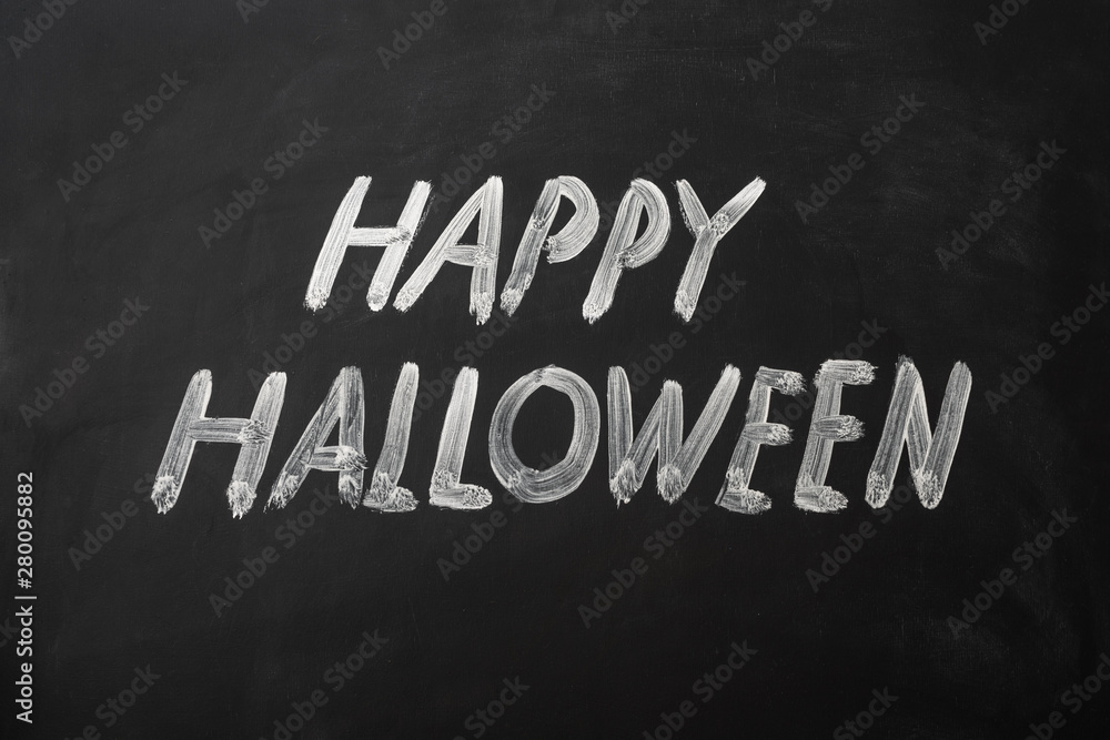 Fototapeta premium Happy Halloween made with chalk on a blackboard.