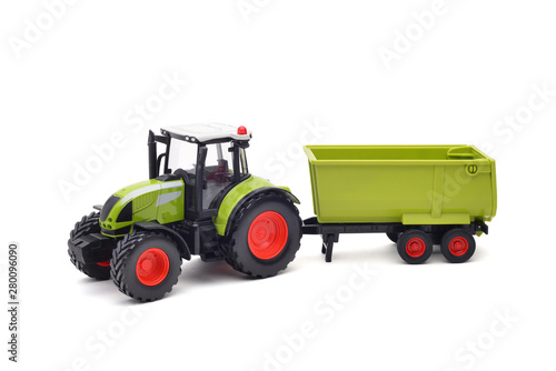 farm green toy tractor with empty trailer, isolated on white background. Copy space background