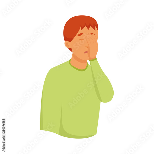 Cute red hair boy in green sweater cover his face with palm