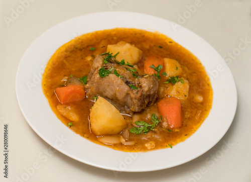 Oxtail stew beautiful closeup on white background with parsley garnish