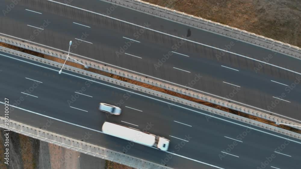 Aerial view of highway. Evening, summer, drone shots, from above, trucks and cars go on the road, transport / 4K Drone Video Aerial view of highway. Evening, summer, drone shots, from above, trucks and cars go on the road, transport / 4K Drone Video