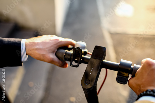 Close up image of a man on an electric scooter paying online