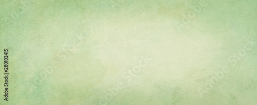 Green background with watercolor texture in abstract vintage pastel green border design with faded textured beige paint color center photo