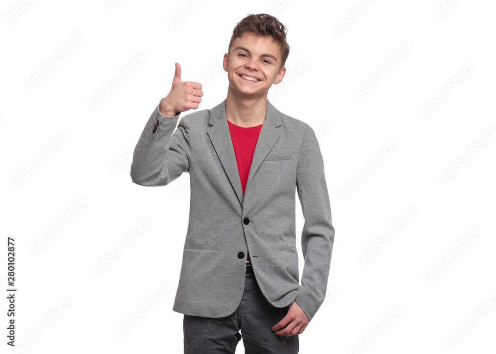 Handsome caucasian Teen Boy in gray suit making Thumb up Gesture, isolated on white background. Teenager looking at camera and smiling. Happy child - portrait. Handsome caucasian Teen Boy in gray suit making Thumb up Gesture, isolated on white background. Teenager looking at camera and smiling. Happy child - portrait.