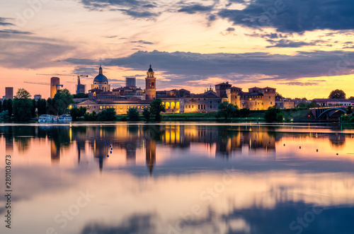 View of the city of Mantua at sunset reflected on the Middle Lake on the Mincio River