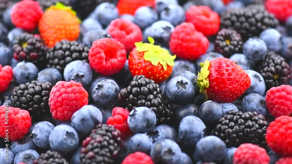 Berries. Various colorful berries background. Strawberry, raspberry, blackberry, blueberry closeup backdrop. Healthy eating. Rotation. Slow motion 4K UHD video footage. 3840X2160 Berries. Various colorful berries background. Strawberry, raspberry, blackberry, blueberry closeup backdrop. Healthy eating. Rotation. Slow motion 4K UHD video footage. 3840X2160