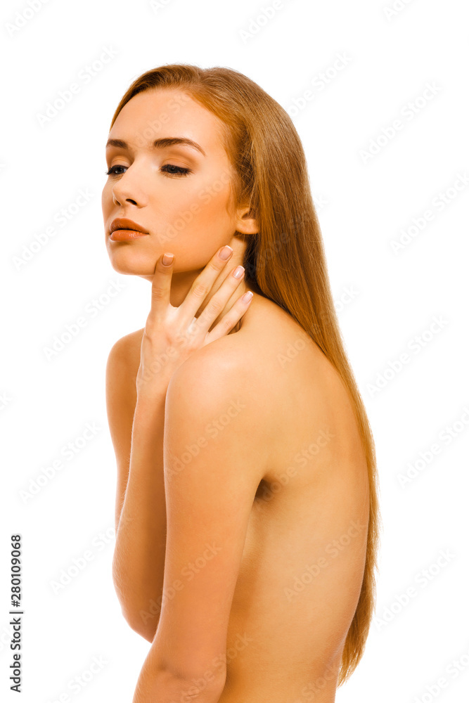 Obraz premium Sexy nude woman covering breast and touching her face with pleasure. Body care.