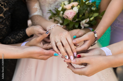 close-up of bridesmaid hands with engagement ring  many bridesmaids hands  consider beauty and admire 