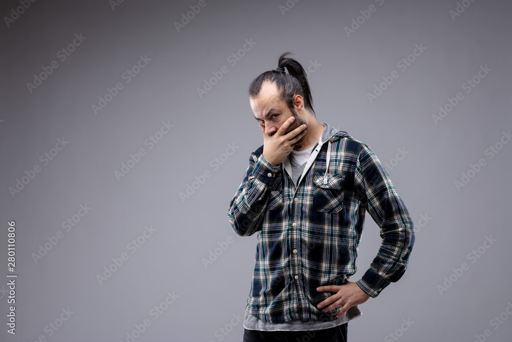 Thoughtful man eyeing the camera with scepticism Thoughtful man eyeing the camera with scepticism
