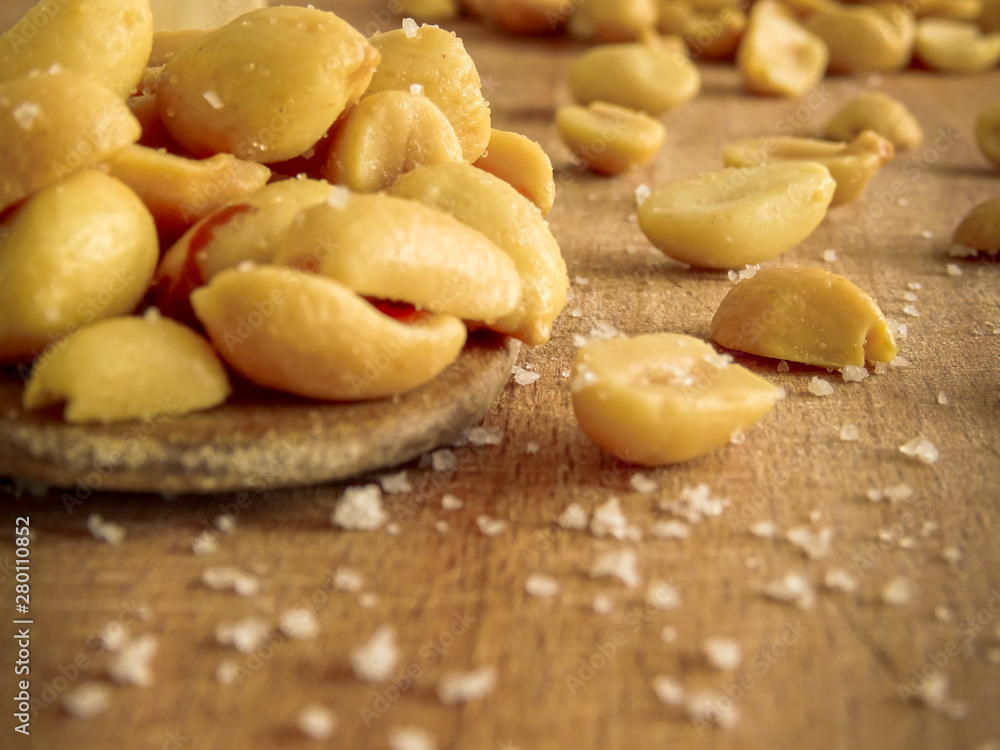 peanut on the wooden and blurry background salty close up peanut on the wooden and blurry background salty close up