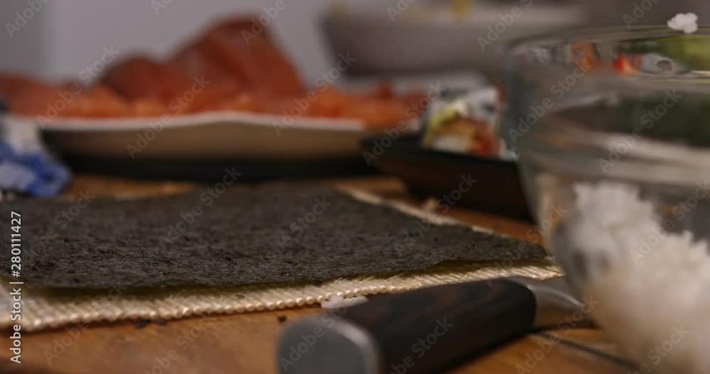 Close view of hands putting rice on seaweed. Preparing sushi background. Close view of hands putting rice on seaweed. Preparing sushi background.