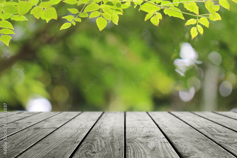 Wooden desk and green leaf nature background. Wooden desk and green leaf nature background.