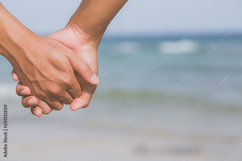 Closeup asian gay couple holding hands together on the beach with relax and leisure in summer, LGBT homosexual legal two man happy and romantic in vacation, relationship sex lover concept. Closeup asian gay couple holding hands together on the beach with relax and leisure in summer, LGBT homosexual legal two man happy and romantic in vacation, relationship sex lover concept.